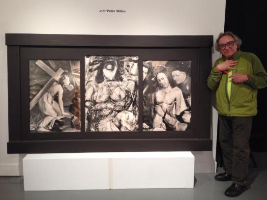 Joel-Peter Witkin standing next to his piece at Paris Photo L.A.