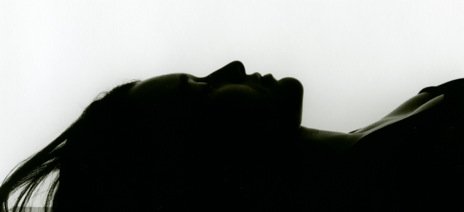 Image: Bettina von Zwehl, Meditations in an Emergency #4, 2018. A photograph of a silhouette of a person laying on their back.